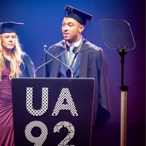 Louie stood at the podium delivering his graduation speech